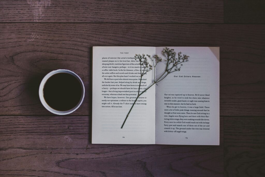  flat‑lay of notebook with ‘Joy’ handwritten and coffee cup for inspiration