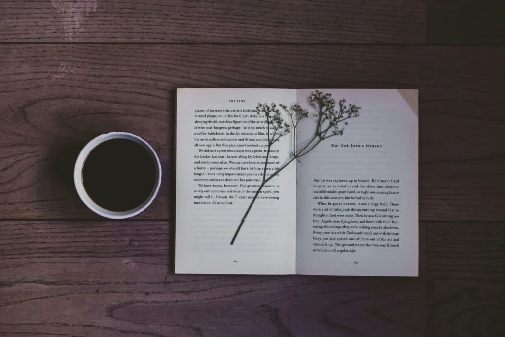  flat‑lay of notebook with ‘Joy’ handwritten and coffee cup for inspiration
