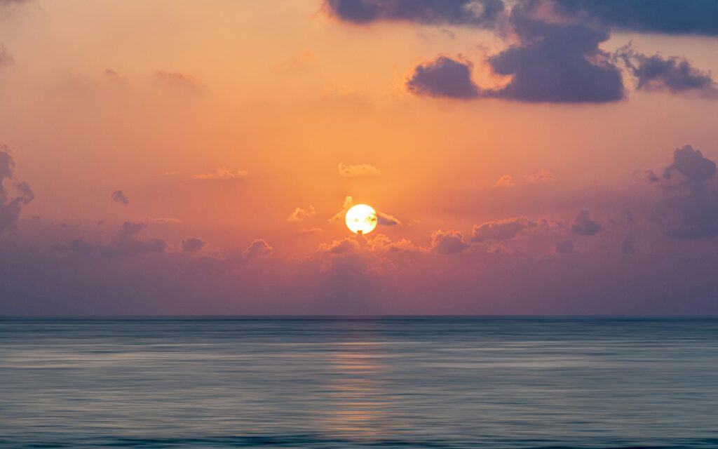 Happiness quotes with golden sunrise over a calm sea