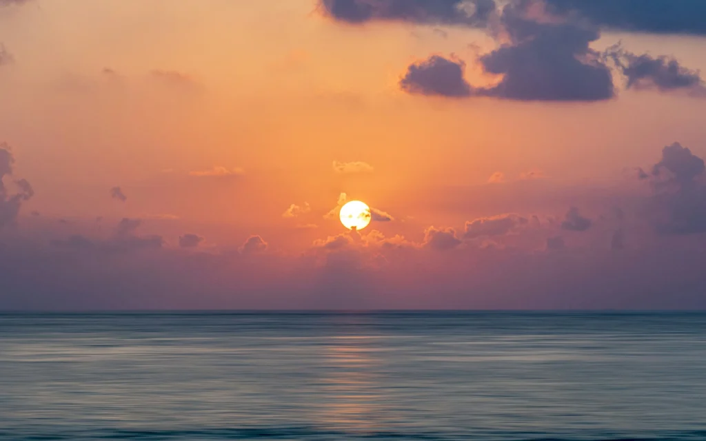  Happiness quotes with golden sunrise over a calm sea