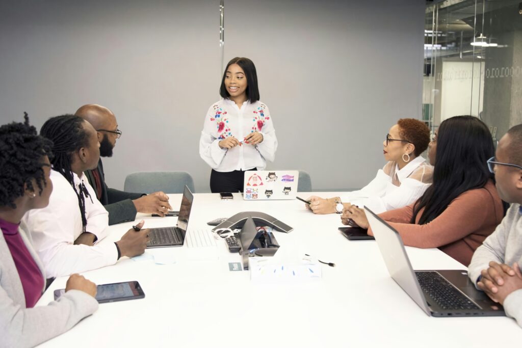 A diverse team of coworkers smiling around a conference table